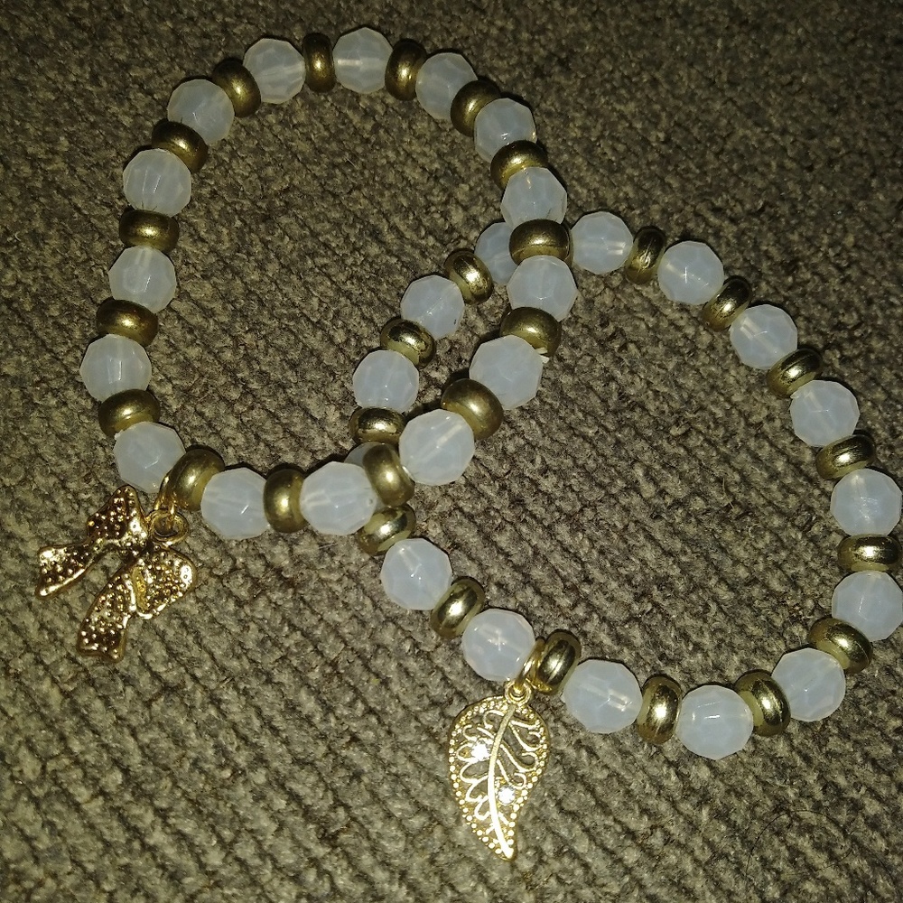 Two white and gold bracelets